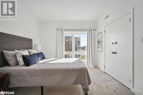 Carpeted bedroom with a closet - 8 Culinary Lane Unit# 402, Barrie, ON - Indoor Photo Showing Bedroom