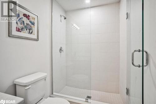 Bathroom featuring toilet and a shower with shower door - 8 Culinary Lane Unit# 402, Barrie, ON - Indoor Photo Showing Bathroom