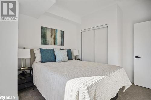 Bedroom featuring a closet and dark colored carpet - 8 Culinary Lane Unit# 402, Barrie, ON - Indoor Photo Showing Bedroom