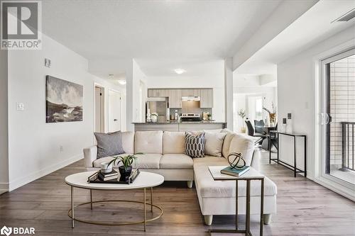 Living room featuring light hardwood / wood-style flooring - 8 Culinary Lane Unit# 402, Barrie, ON - Indoor Photo Showing Living Room