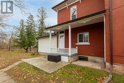 Entrance to property featuring a yard and a porch - 