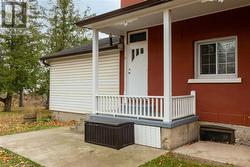 Property entrance featuring covered porch - 