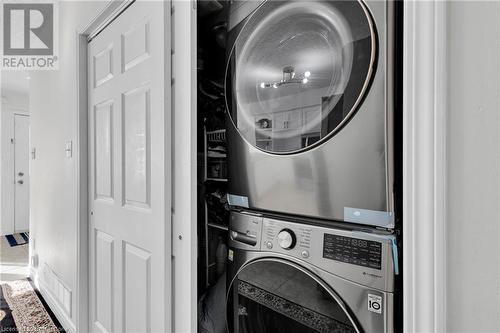 Clothes washing area with stacked washer / drying machine - 50 Howe Drive Unit# 17B, Kitchener, ON - Indoor Photo Showing Laundry Room