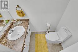 Bathroom featuring vanity, tile patterned floors, and toilet - 