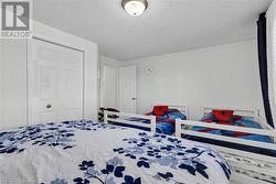 Bedroom featuring a closet and a textured ceiling - 