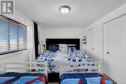 Bedroom featuring a textured ceiling - 