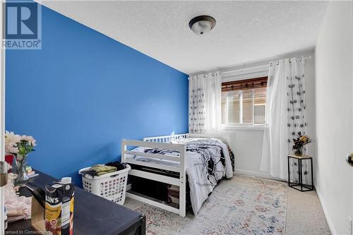 Bedroom with a textured ceiling and light carpet - 50 Howe Drive Unit# 17B, Kitchener, ON - Indoor Photo Showing Bedroom