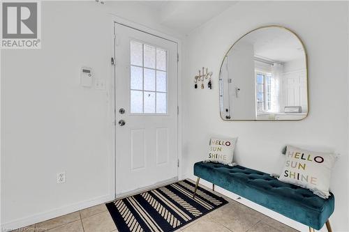 Foyer entrance with a wealth of natural light and light tile patterned floors - 50 Howe Drive Unit# 17B, Kitchener, ON - Indoor Photo Showing Other Room