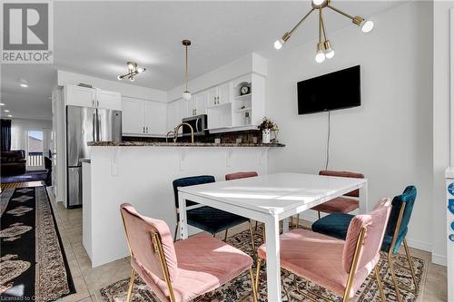 Dining space with light tile patterned floors - 50 Howe Drive Unit# 17B, Kitchener, ON - Indoor Photo Showing Dining Room