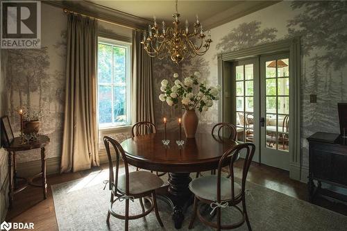 Dining space with hardwood / wood-style floors, a notable chandelier, ornamental molding, and french doors - 42 Burton Avenue, Barrie, ON - Indoor Photo Showing Dining Room With Fireplace