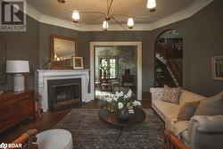 Living room featuring dark hardwood / wood-style flooring and crown molding - 