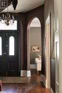 Foyer entrance with dark hardwood / wood-style floors - 