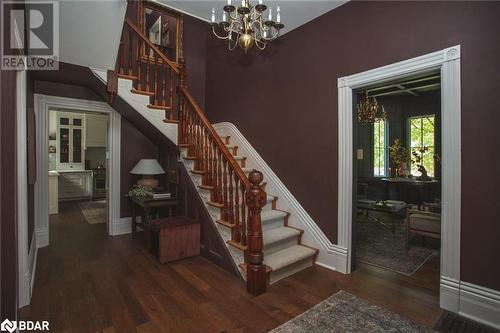 Stairway with hardwood / wood-style flooring and a chandelier - 42 Burton Avenue, Barrie, ON - Indoor Photo Showing Other Room