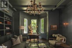 Sitting room with hardwood / wood-style floors, beamed ceiling, and coffered ceiling - 