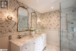 Bathroom featuring vanity, tile patterned floors, and a shower with shower door - 