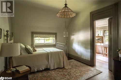 Bedroom featuring hardwood / wood-style flooring and multiple windows - 42 Burton Avenue, Barrie, ON - Indoor Photo Showing Bedroom