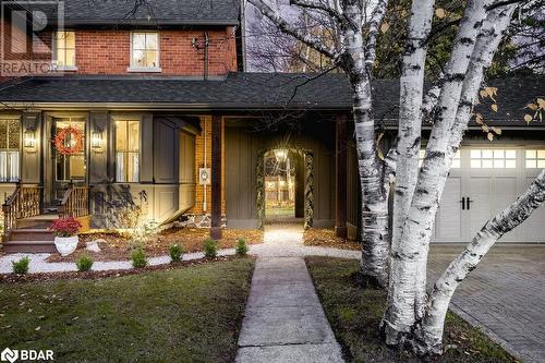 Property entrance with a garage, covered porch, and a yard - 42 Burton Avenue, Barrie, ON - Outdoor