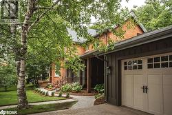 View of home's exterior with a garage and a yard - 