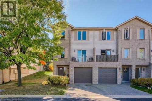 Multi unit property featuring a garage - 230 Blackhorne Drive Unit# 19, Kitchener, ON - Outdoor With Facade