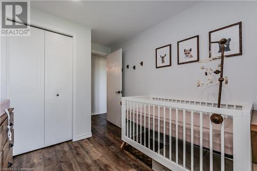 Bedroom featuring dark hardwood / wood-style flooring, a closet, and a nursery area - 230 Blackhorne Drive Unit# 19, Kitchener, ON - Indoor Photo Showing Bedroom