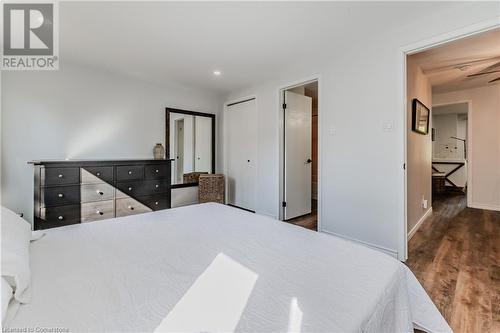 Bedroom with ensuite bathroom and dark hardwood / wood-style flooring - 230 Blackhorne Drive Unit# 19, Kitchener, ON - Indoor Photo Showing Bedroom