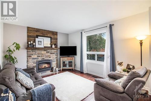 The cozy family room on the main floor offers a gas fireplace as a centerpiece. - 807 Brissac Way, Ottawa, ON - Indoor Photo Showing Living Room With Fireplace