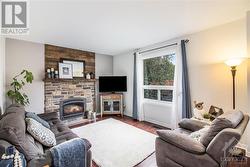 The cozy family room on the main floor offers a gas fireplace as a centerpiece. - 