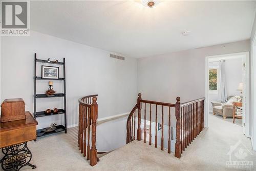 A stunning circular staircase leads you to the second floor, where four spacious bedrooms await. - 807 Brissac Way, Ottawa, ON - Indoor Photo Showing Other Room