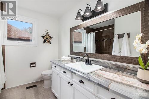 The second-floor bathroom is equally impressive, featuring granite counters and elegant tile work - 807 Brissac Way, Ottawa, ON - Indoor Photo Showing Bathroom