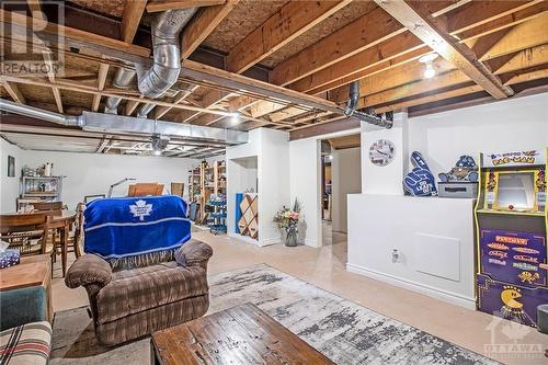 The lower level offers a partly finished space which includes a recreation room, workshop, partial bath, and ample storage. - 807 Brissac Way, Ottawa, ON - Indoor Photo Showing Basement