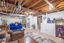 The lower level offers a partly finished space which includes a recreation room, workshop, partial bath, and ample storage. - 