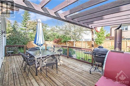 Step outside to a beautifully private, fenced backyard that’s perfect for relaxation or entertaining, featuring a large deck, gardens, and a semi-in-ground heated saltwater "Aquabois" pool. - 807 Brissac Way, Ottawa, ON - Outdoor With Deck Patio Veranda With Exterior