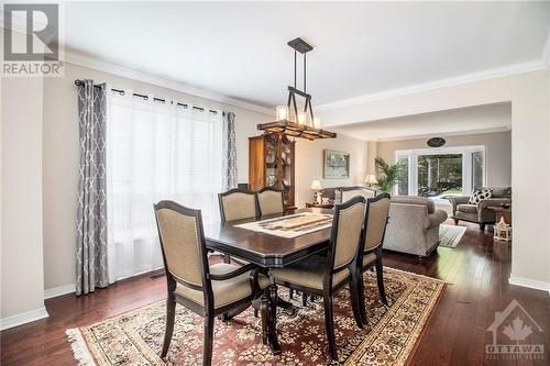 The main level boasts rich hardwood and tile floors, with sunlit windows filling the space with natural light. - 807 Brissac Way, Ottawa, ON - Indoor Photo Showing Dining Room