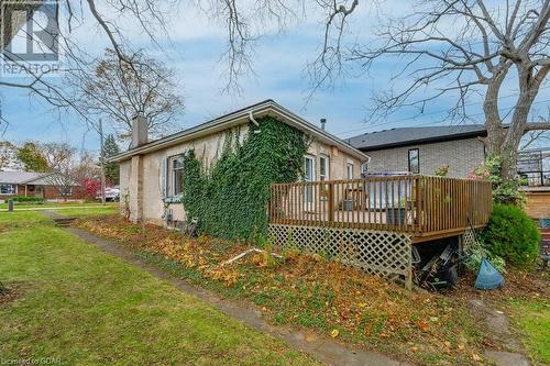 Rear view of property with a lawn and a wooden deck - 55 Edgehill Drive, Guelph, ON - Outdoor With Deck Patio Veranda