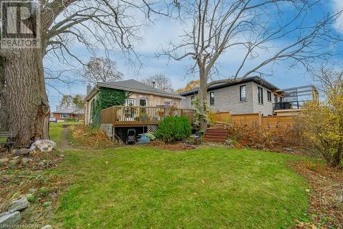 Back of property featuring a wooden deck and a lawn - 55 Edgehill Drive, Guelph, ON - Outdoor