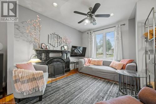 Sitting room featuring hardwood / wood-style floors, a fireplace, and ceiling fan - 55 Edgehill Drive, Guelph, ON - Indoor Photo Showing Living Room With Fireplace