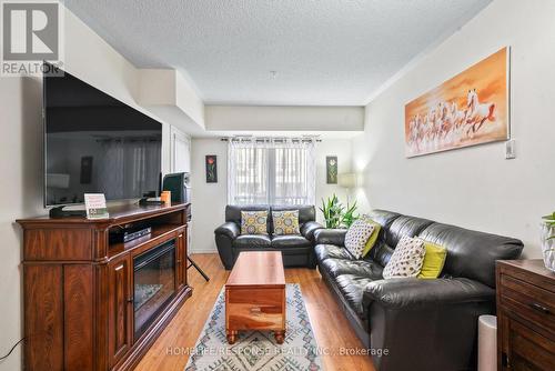 124 - 10 Mendelssohn Street, Toronto, ON - Indoor Photo Showing Living Room With Fireplace