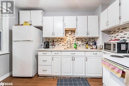 Kitchen with white cabinets, sink, and white appliances - 77 Province Street N, Hamilton, ON - Indoor Photo Showing Kitchen