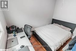 Bedroom with dark wood-type flooring - 