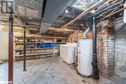 Basement with washing machine and clothes dryer and gas water heater - 