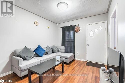 Living room with wood-type flooring and a textured ceiling - 77 Province Street N, Hamilton, ON - Indoor Photo Showing Living Room