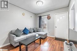 Living room with wood-type flooring and a textured ceiling - 