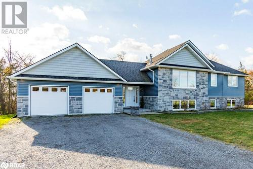 View of front facade featuring a garage and a front lawn - 1647 Lakeside Drive, Hillier, ON - Outdoor With Facade