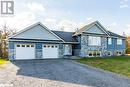 View of front facade featuring a garage and a front lawn - 1647 Lakeside Drive, Hillier, ON  - Outdoor With Facade 