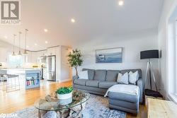 Living room featuring light wood-type flooring and vaulted ceiling - 