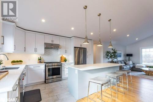 Kitchen featuring white cabinetry, sink, appliances with stainless steel finishes, a kitchen island, and pendant lighting - 1647 Lakeside Drive, Hillier, ON - Indoor Photo Showing Kitchen With Upgraded Kitchen