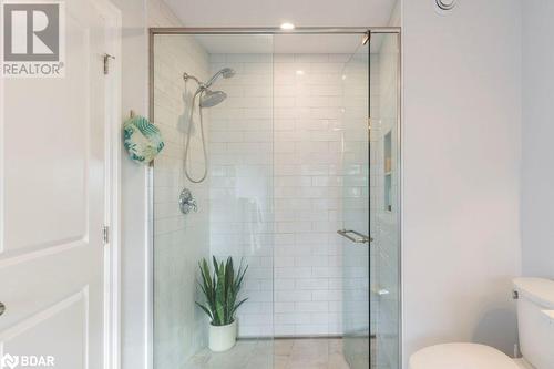 Bathroom featuring toilet and walk in shower - 1647 Lakeside Drive, Hillier, ON - Indoor Photo Showing Bathroom