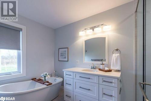 Bathroom featuring a tub and vanity - 1647 Lakeside Drive, Hillier, ON - Indoor Photo Showing Bathroom