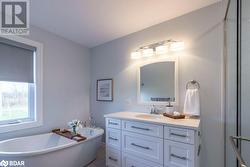 Bathroom featuring a tub and vanity - 