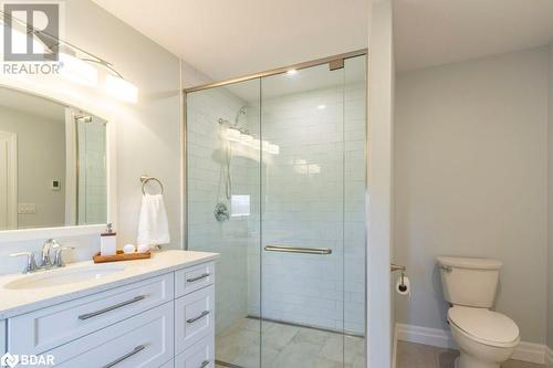 Bathroom with walk in shower, vanity, and toilet - 1647 Lakeside Drive, Hillier, ON - Indoor Photo Showing Bathroom